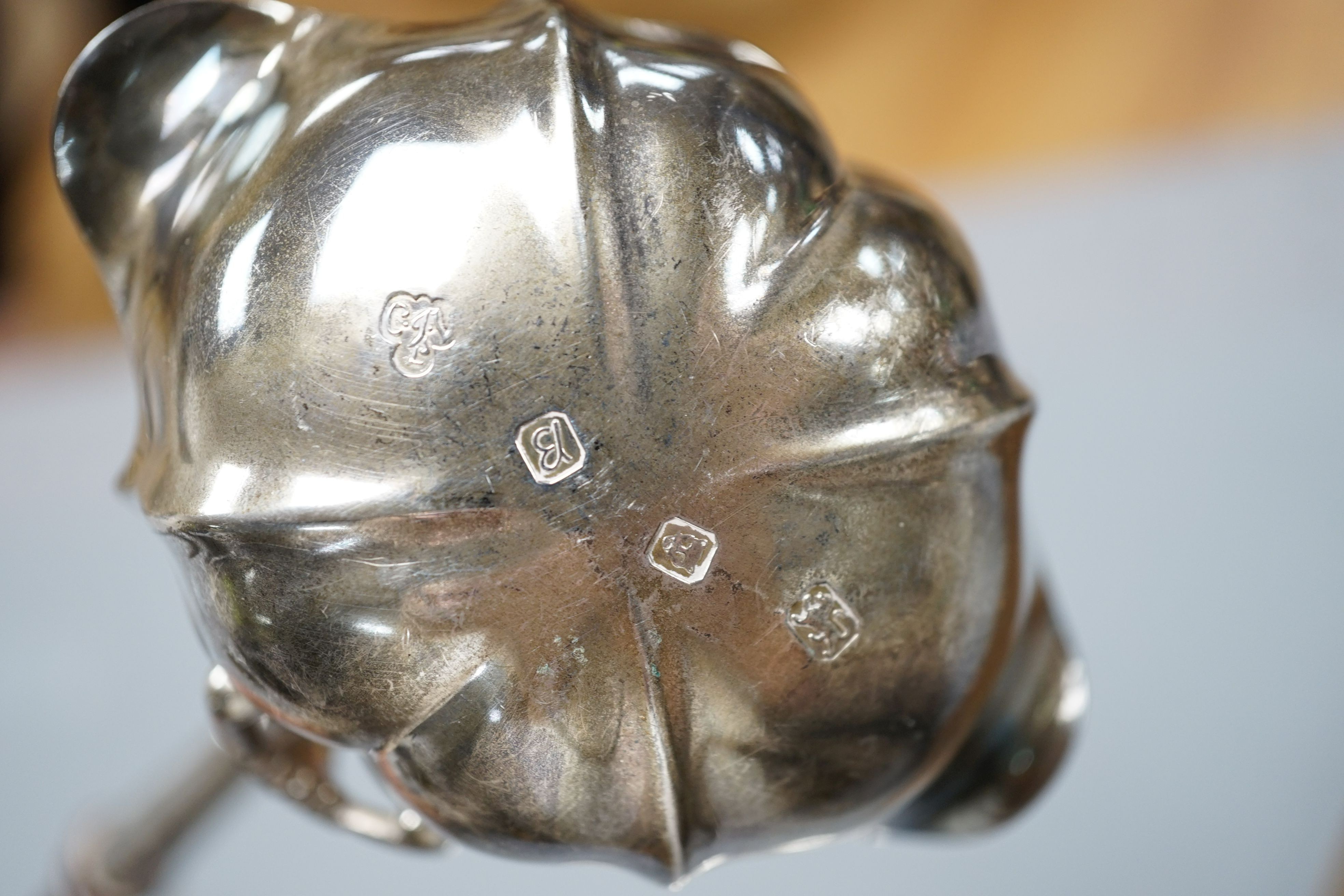 A Georgian style silver toddy ladle, London 1976, a silver mounted rectangular photograph frame, a caddy spoon, and a vesta case stamped Sterling